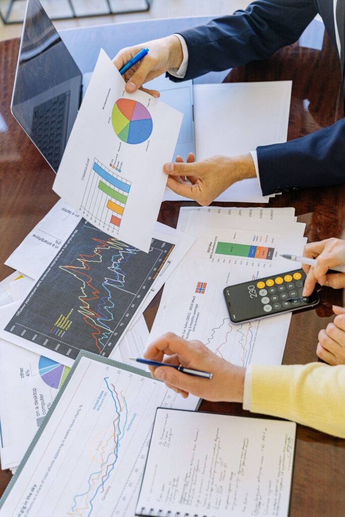 People reviewing documents and reports on a desk
