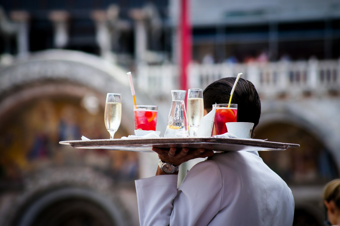 Waiter serving drinks to guests
