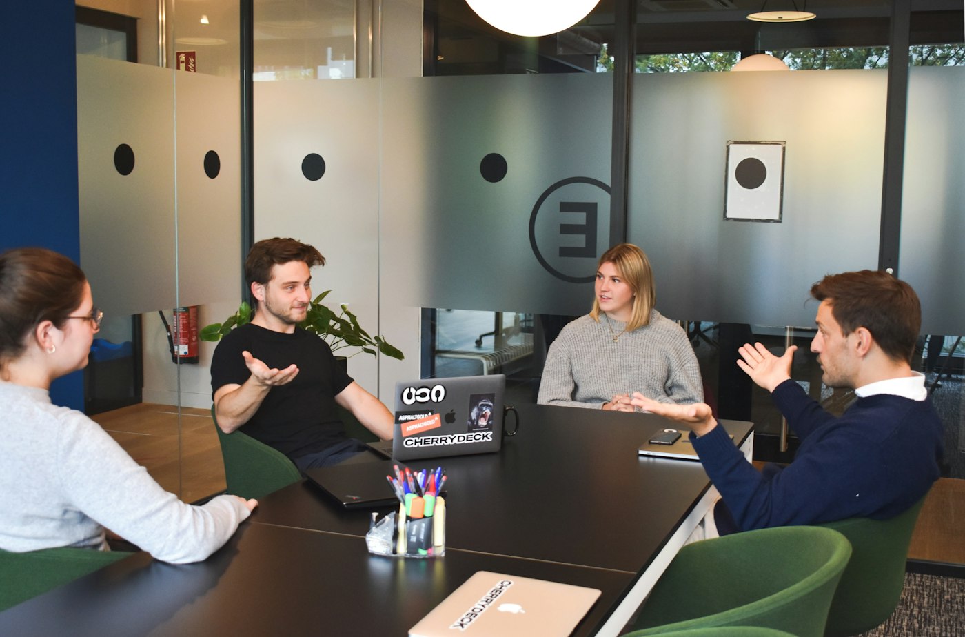 Colleagues meeting around a table in a modern office