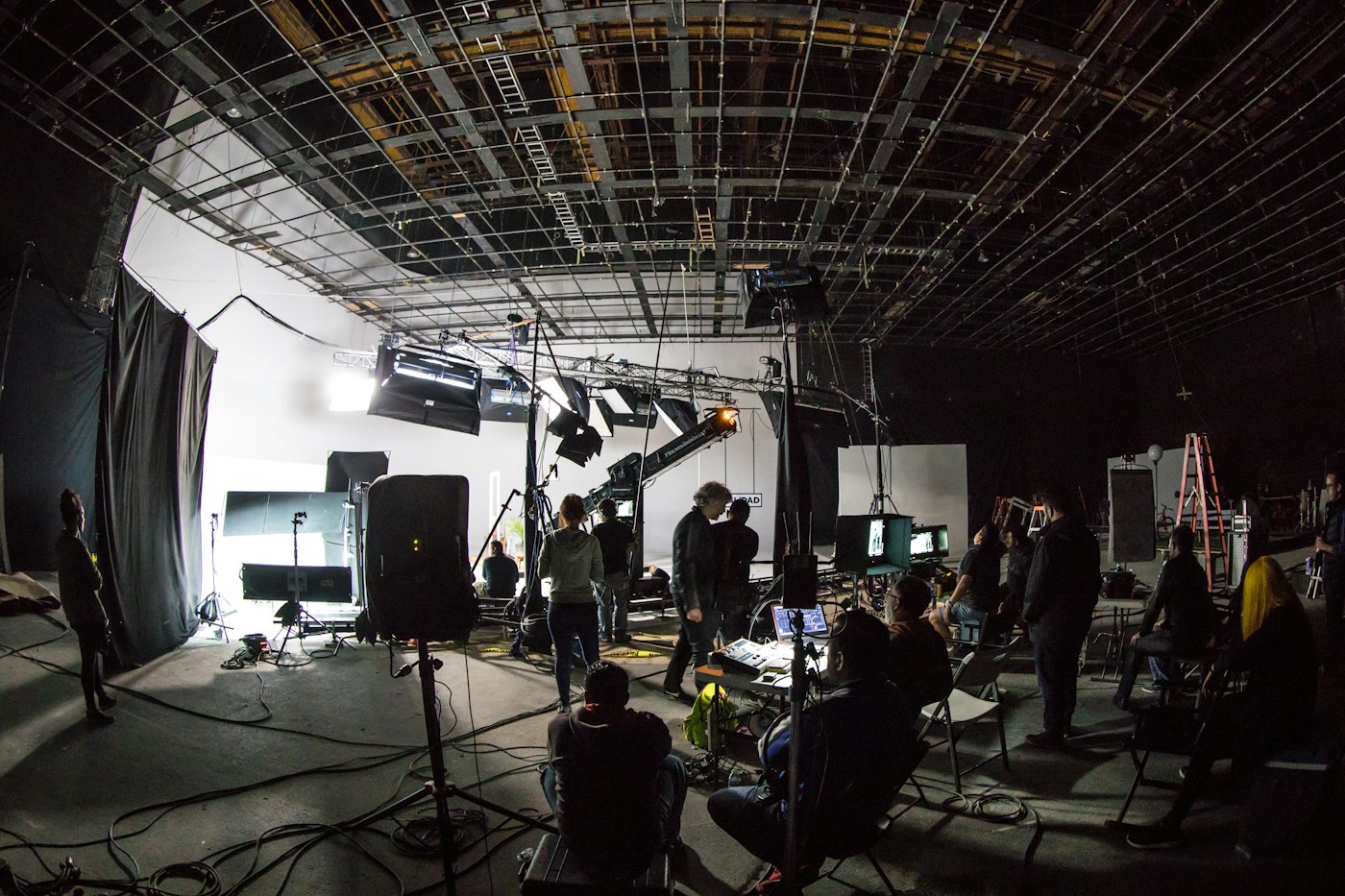 Production crew working on a soundstage with lighting and cameras