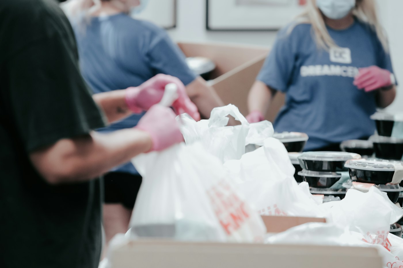 Volunteers packing food into bags