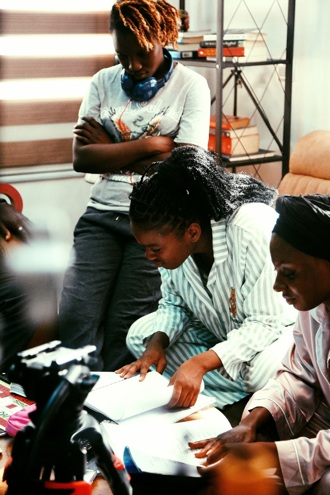 Three women reviewing papers together indoors